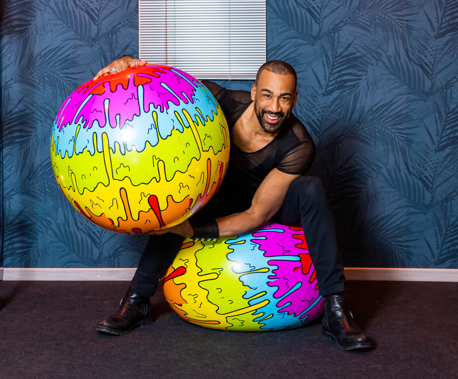 Picture of a man with two SHOSU Amsterdam Pride Beach balls
